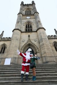 Bombed out church winter wonderland Santa and Elf